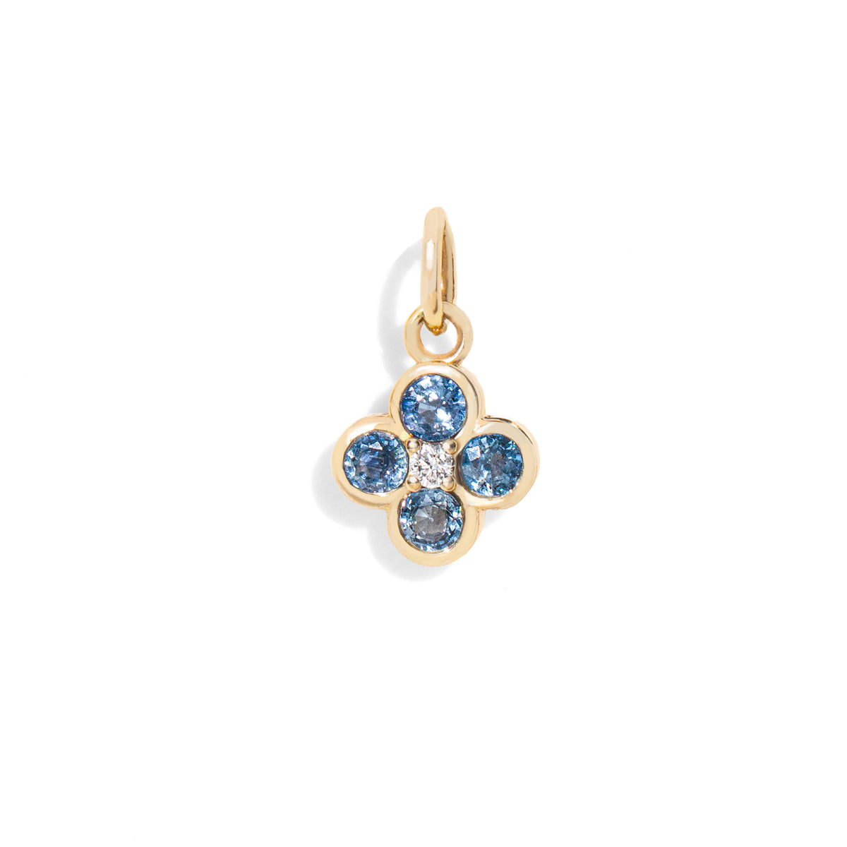 Gold pendant with blue gemstones on a white background
