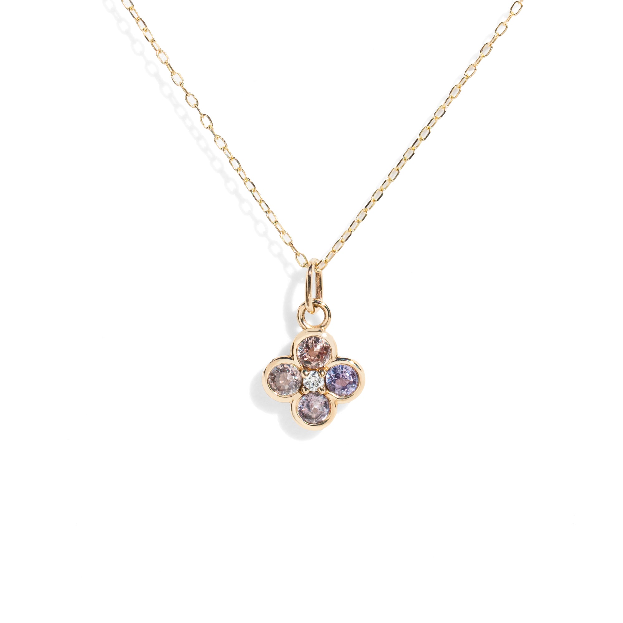 Gold necklace with a four-leaf clover pendant featuring multicolored gemstones on a white background.