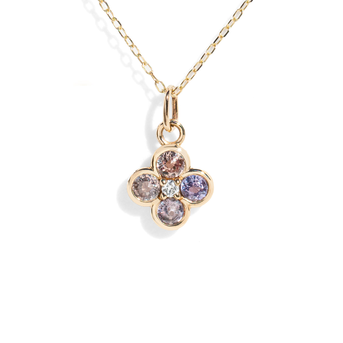 Gold necklace with a four-leaf clover pendant featuring multicolored gemstones on a white background.