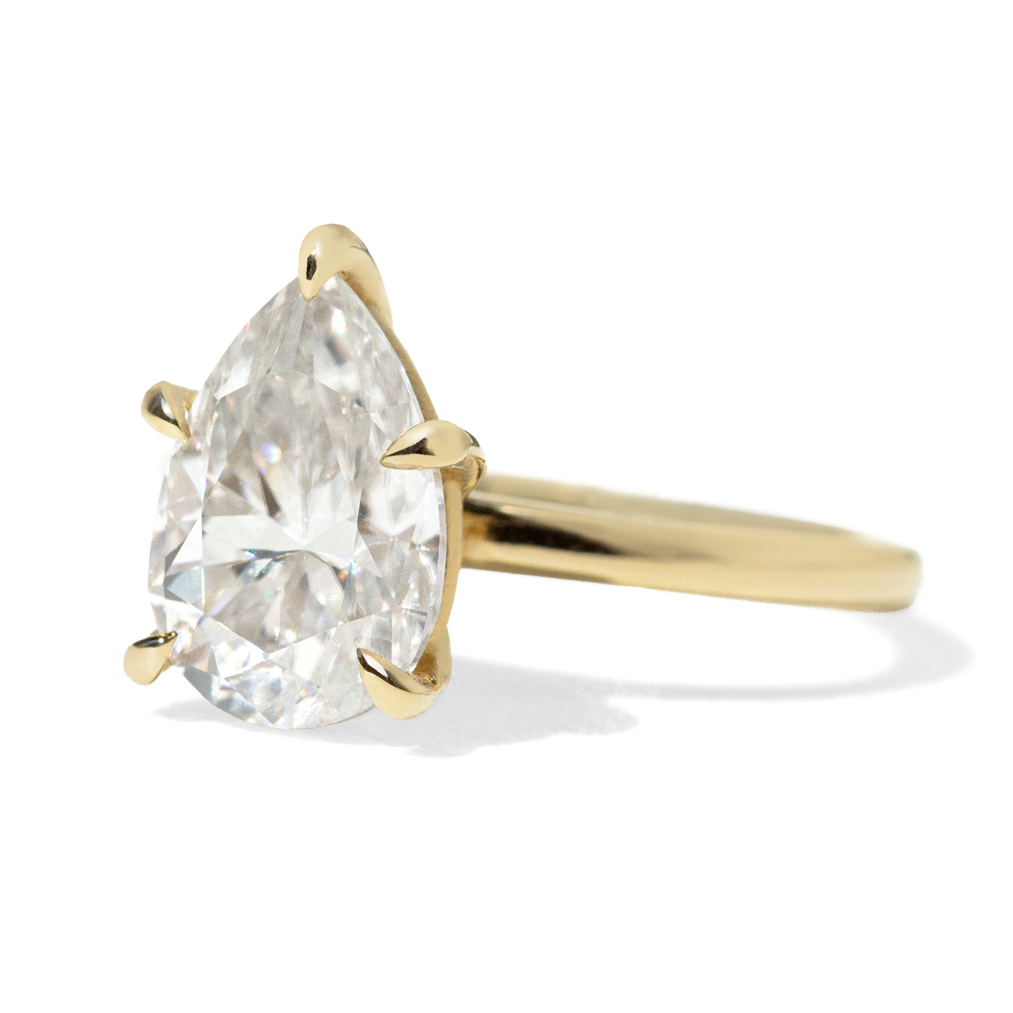 Jamie Park Jewelry | Sunshine Pear Cut Ring The Sunshine Pear Cut Solitaire Ring beautifully blends modern style with elegance. Available with lab white sapphire, moissanite, or IGI certified diamond, this ring is sure to sparkle and impress. The five-prong design ensures the center stone is securely held. The size shown is 2.5ct.