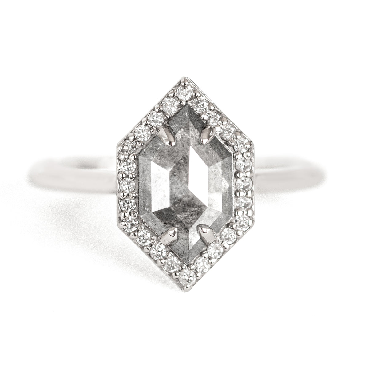 The Dunn 1.52 ct. Salt and Pepper Diamond Halo Ring is an absolute show-stopper. It features a modern hexagon diamond surrounded by a sparkling white diamond halo.