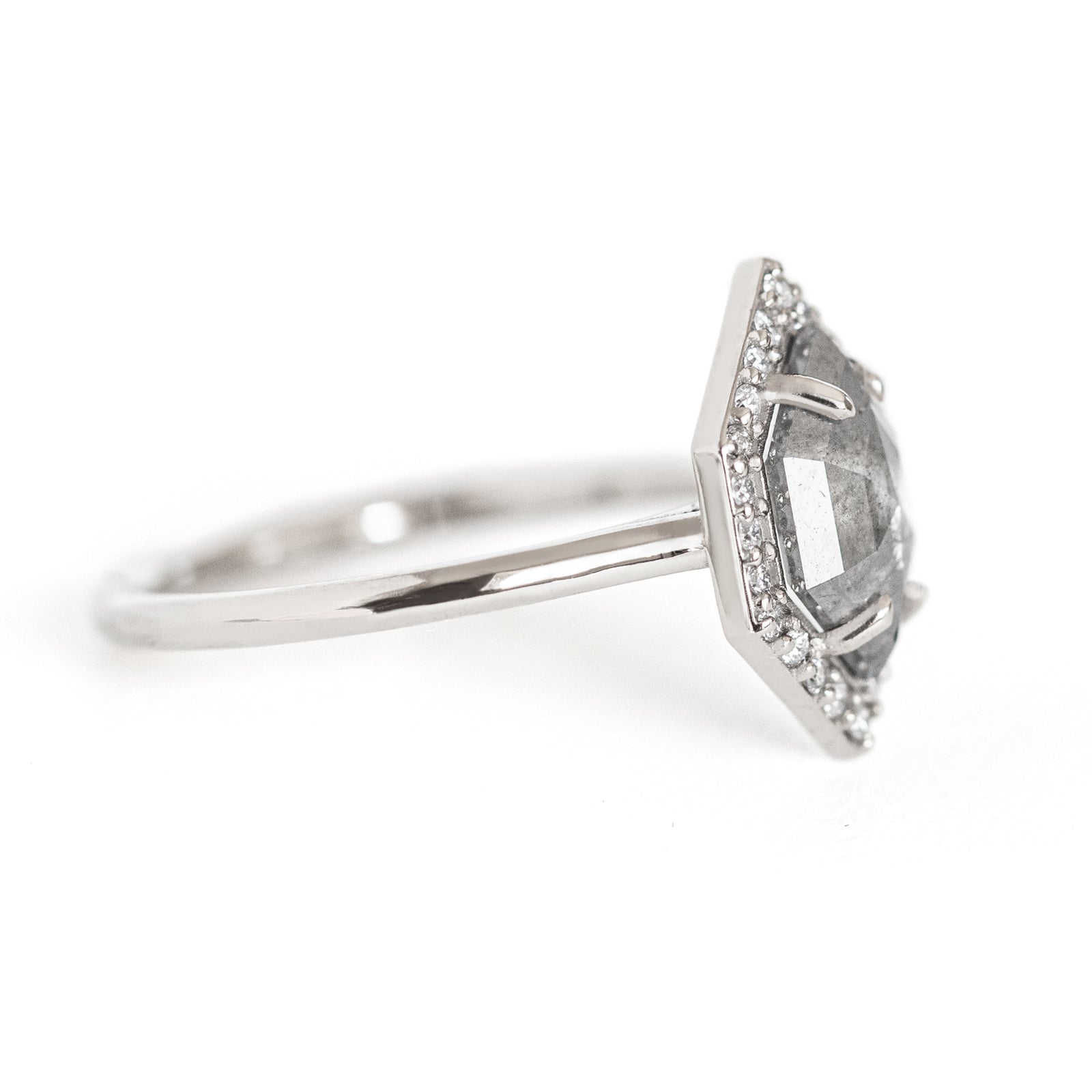 The Dunn 1.52 ct. Salt and Pepper Diamond Halo Ring is an absolute show-stopper. It features a modern hexagon diamond surrounded by a sparkling white diamond halo.