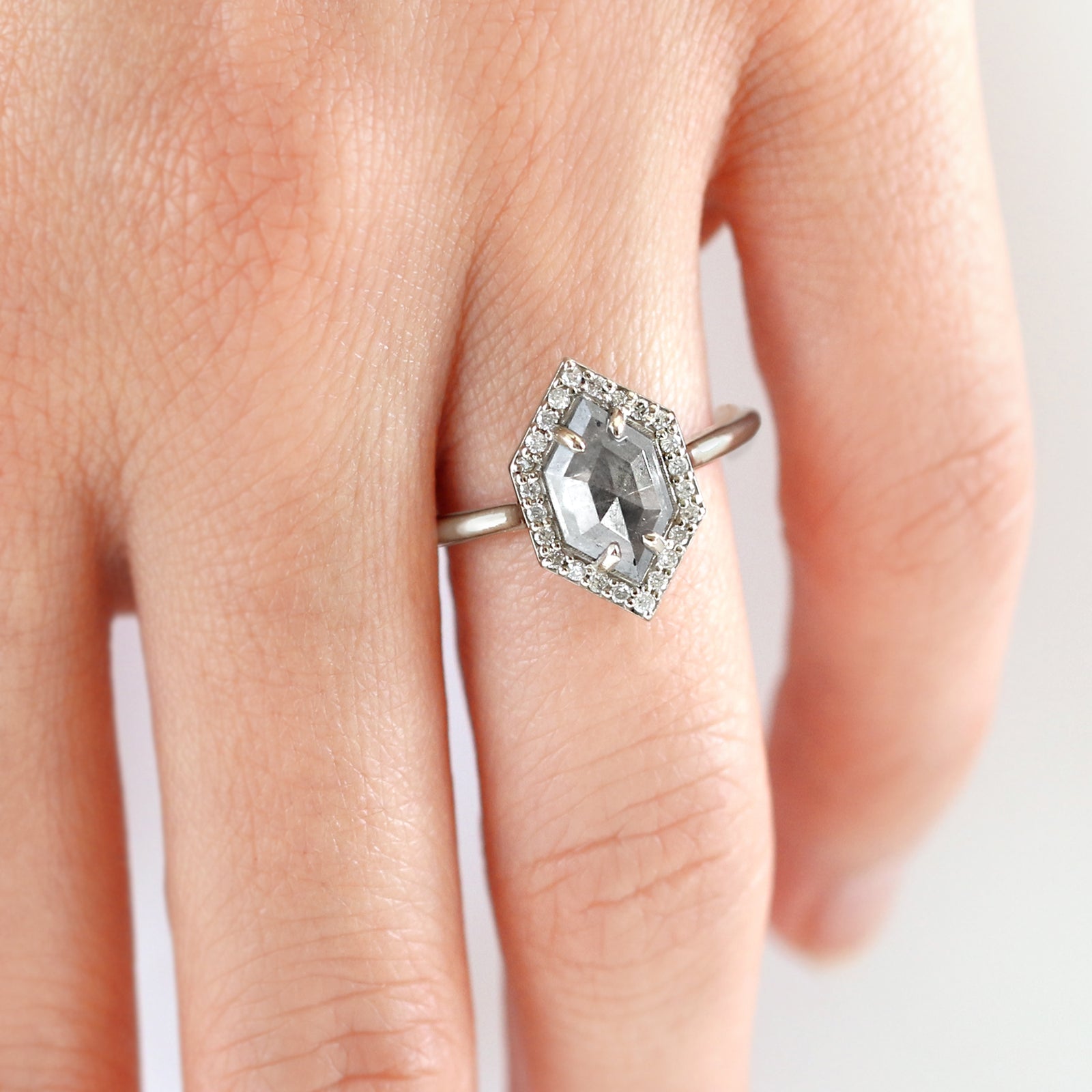 The Dunn 1.52 ct. Salt and Pepper Diamond Halo Ring is an absolute show-stopper. It features a modern hexagon diamond surrounded by a sparkling white diamond halo.