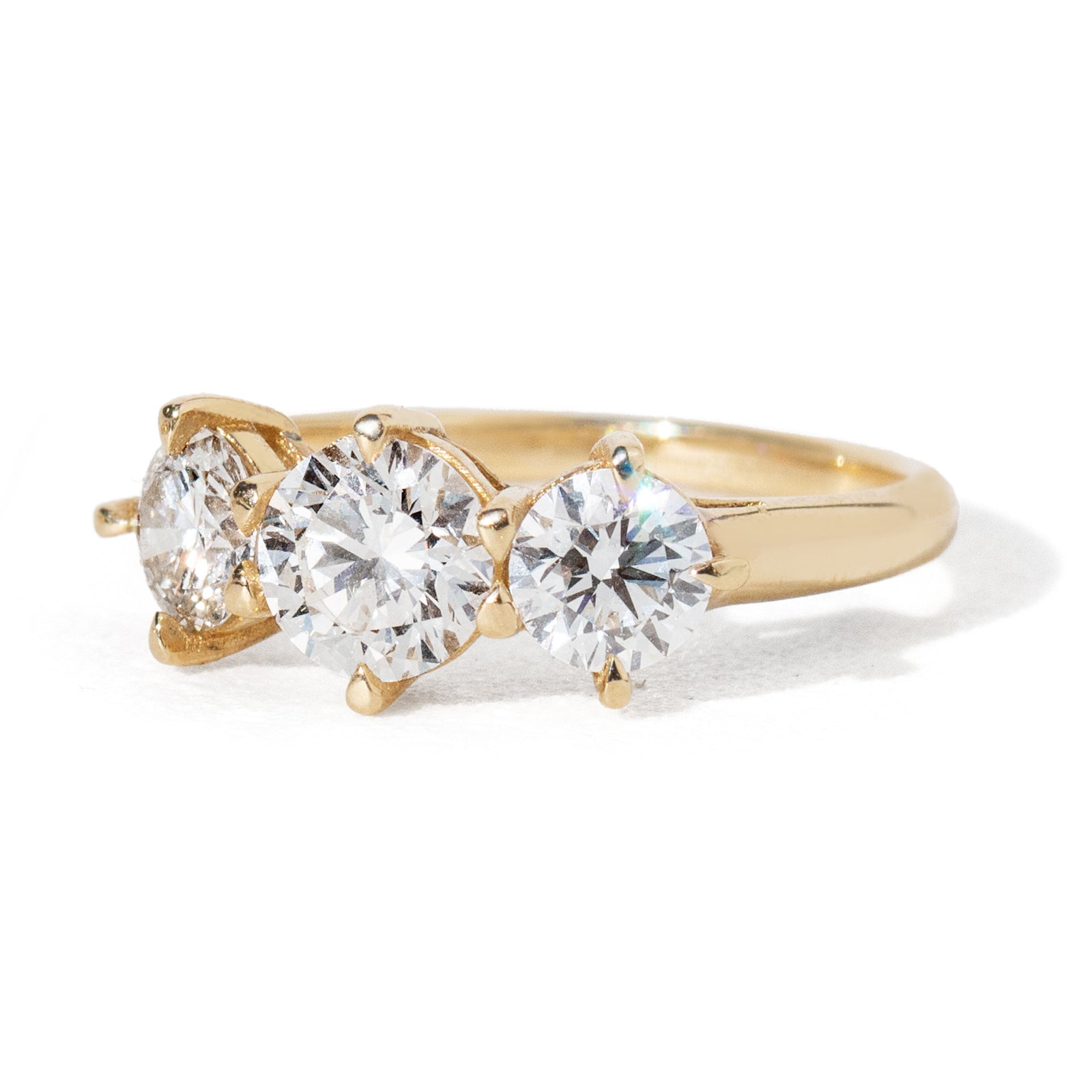 This three-diamond ring features a stunning 0.85-carat center diamond, flanked by two half-carat diamonds in our Empire design, representing a past-present-future or trinity ring. This luxurious piece effortlessly combines vintage charm with a modern aesthetic. It is the perfect choice for engagements, milestone celebrations, birthdays, and anniversaries, making it a versatile and timeless addition to any collection.