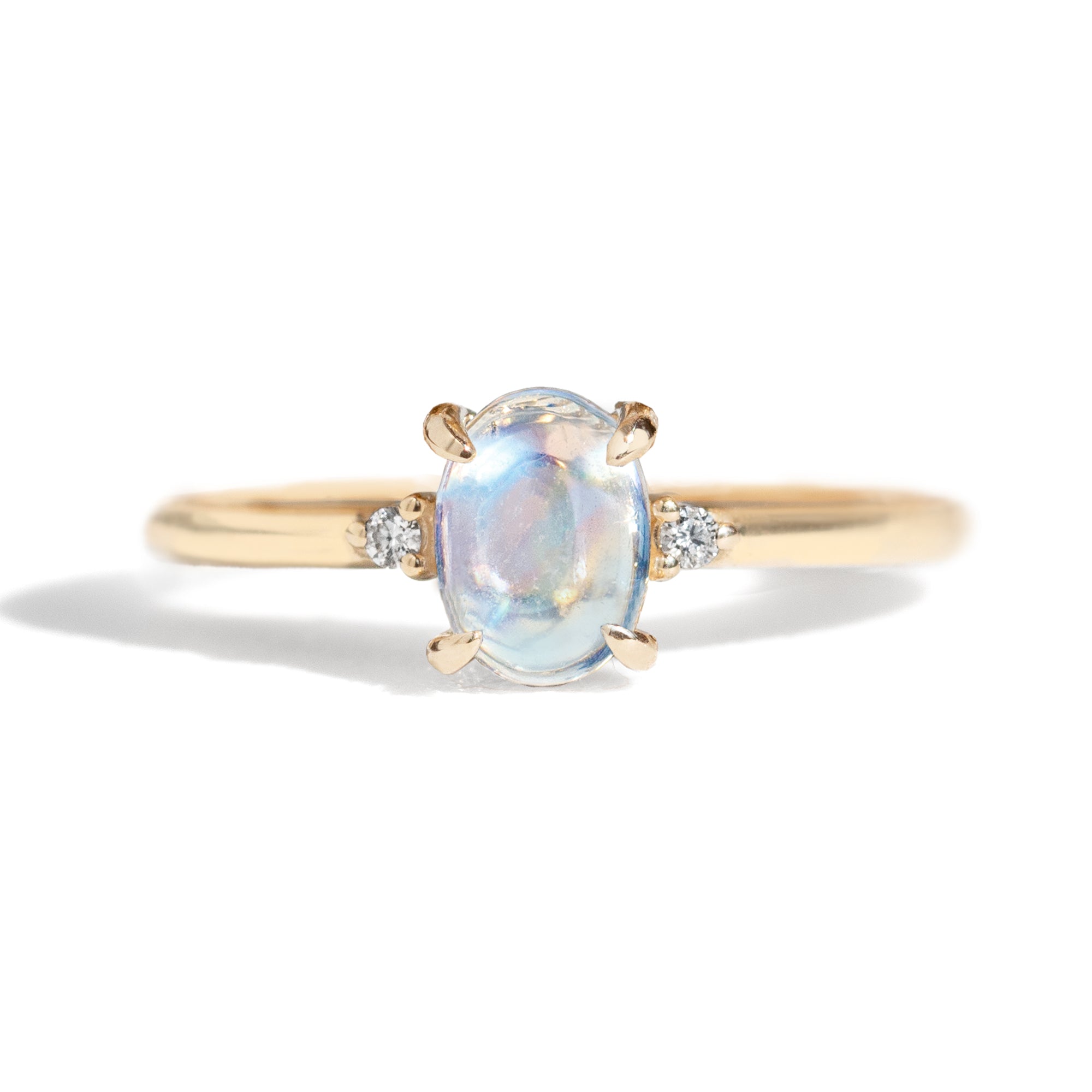 The classic Grace Ring's three stone design makes it perfect for your special day. This unique ring features an oval rainbow moonstone adorned with small diamonds, making it a truly one-of-a-kind piece. Pair this ring with Blossom Moonstone Contour Band to create your dream ring stack.&nbsp;