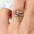 The 1.13 ctw. Pink and Yellow Sapphire Half Halo Ring features a 0.65 ct pink sapphire at its center, framed by a half halo of pink and yellow sapphires. The playful, colorful halo design is truly one of a kind. This ring is perfect for those who appreciate both colors and unique designs.