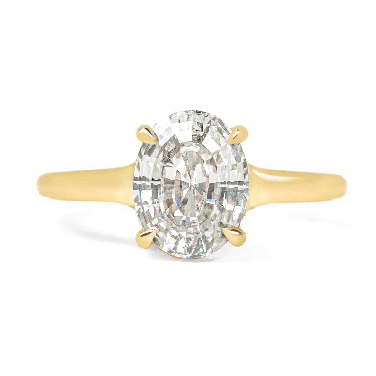 Expertly crafted for vintage lovers, the Vessel Solitaire Ring features a luxurious cup setting on a beautifully curved tapered band. The unique oval step cut moissanite or diamond creates a dazzling discoball effect, showcasing the gemstone&#39;s stunning sparkle. Elevate your style with rich gold tones and timeless elegance.