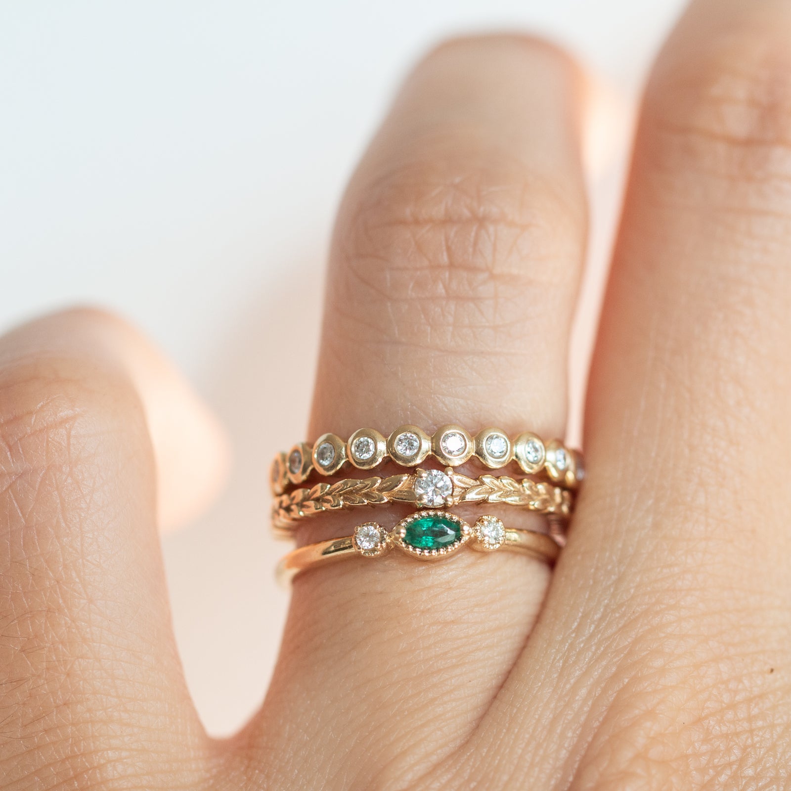 Made for vintage lovers, this Nokes Ring features a bold green emerald in a marquise cut, complemented by sparkling diamonds on either side, all set in a beautiful milgrain details. Its understated design makes it ideal for everyday wear, a thoughtful gift, or as a delicate engagement ring.