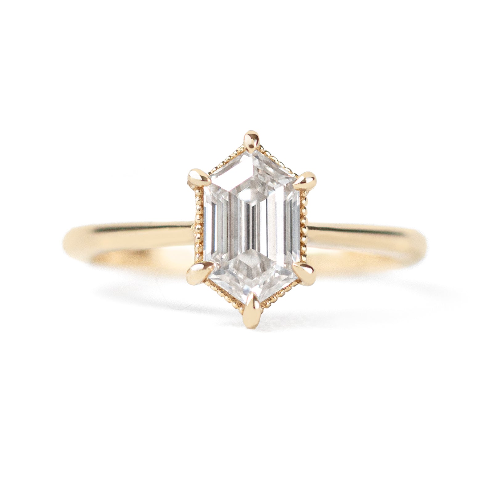 The Hera Ring showcases a 1.5ct hexagon lab diamond or moissanite, with a delicately highlighted hexagon step cut and milgrain accents on the setting. This elegant and romantic ring effortlessly combines antique charm with a modern aesthetic. It serves as the perfect choice for engagements, milestone celebrations, birthdays, and anniversaries, making it a versatile and timeless piece.