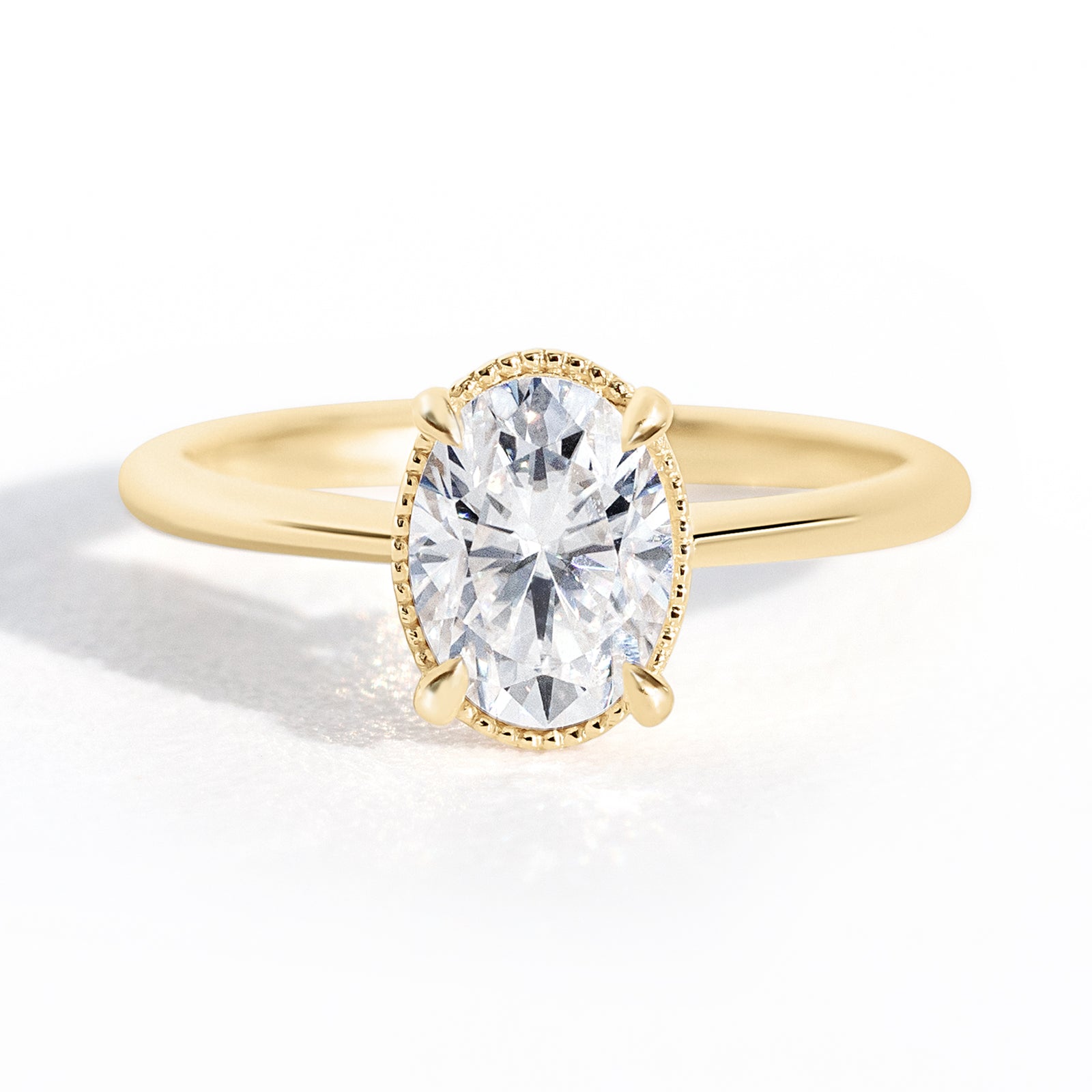 The Hera Ring features a 1ct. oval diamond or moissanite set in a delicately milgrained setting. This elegant and romantic design effortlessly blends old-world charm with a modern aesthetic. It’s the perfect choice for engagements, milestone celebrations, birthdays, and anniversaries, making it a timeless piece.