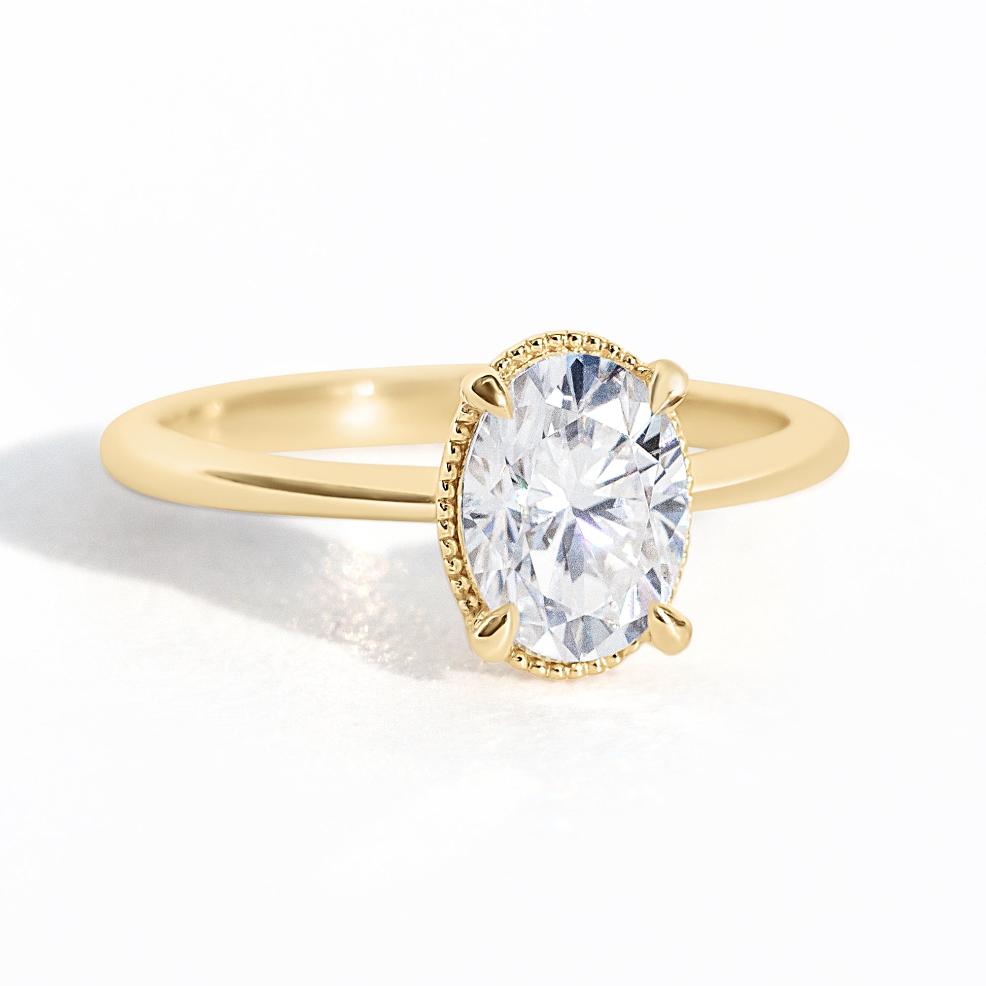 The Hera Ring features a 1ct. oval diamond or moissanite set in a delicately milgrained setting. This elegant and romantic design effortlessly blends old-world charm with a modern aesthetic. It’s the perfect choice for engagements, milestone celebrations, birthdays, and anniversaries, making it a timeless piece.