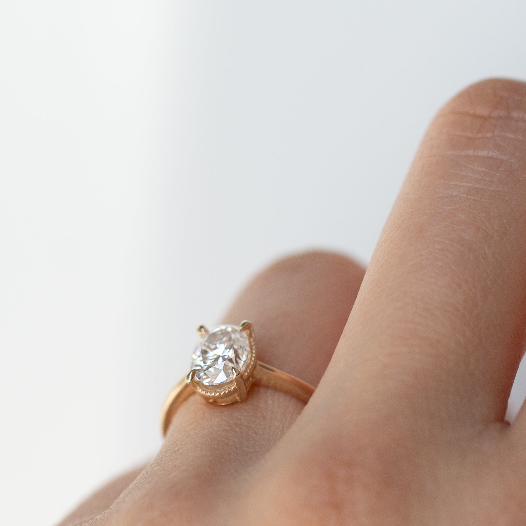 The Hera Ring features a 1ct. oval diamond or moissanite set in a delicately milgrained setting. This elegant and romantic design effortlessly blends old-world charm with a modern aesthetic. It’s the perfect choice for engagements, milestone celebrations, birthdays, and anniversaries, making it a timeless piece.