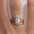 Gold milgrain ring with a 1.5 carat old mine cut diamond stacked with diamond bands on a hand 