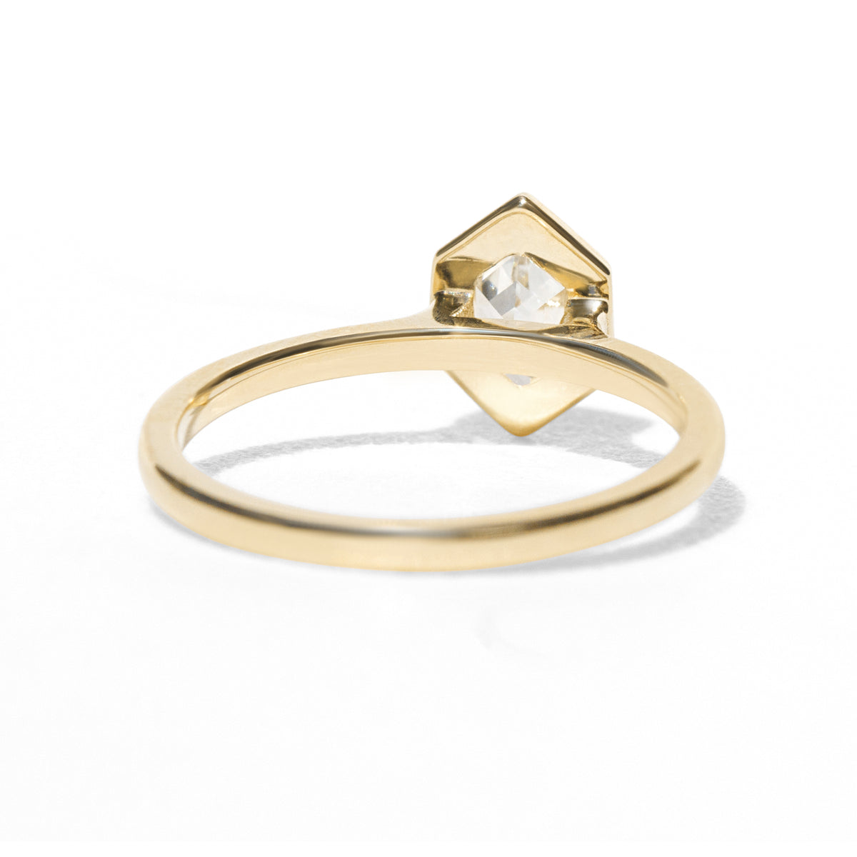 Gold ring with a diamond on a white background