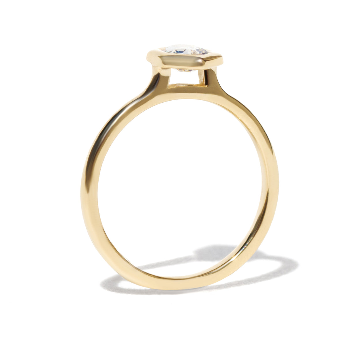 Gold ring with a diamond on a white background