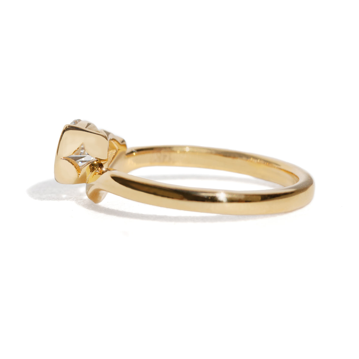 Gold ring with a diamond on a white background