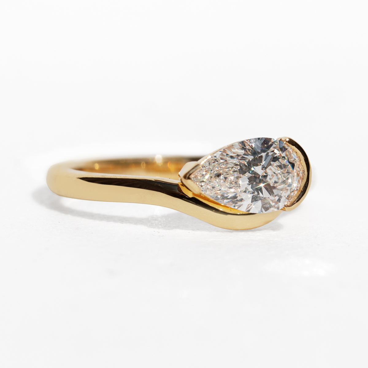 Gold ring with a large diamond on a white background