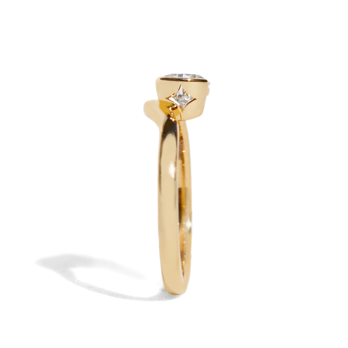 Gold ring with a diamond on a white background