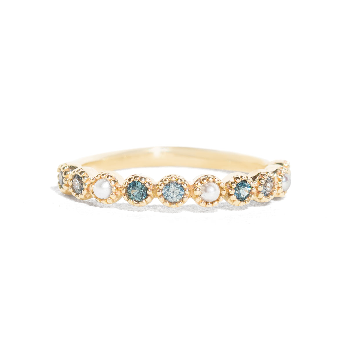 Gold ring with embedded gemstones on a white background