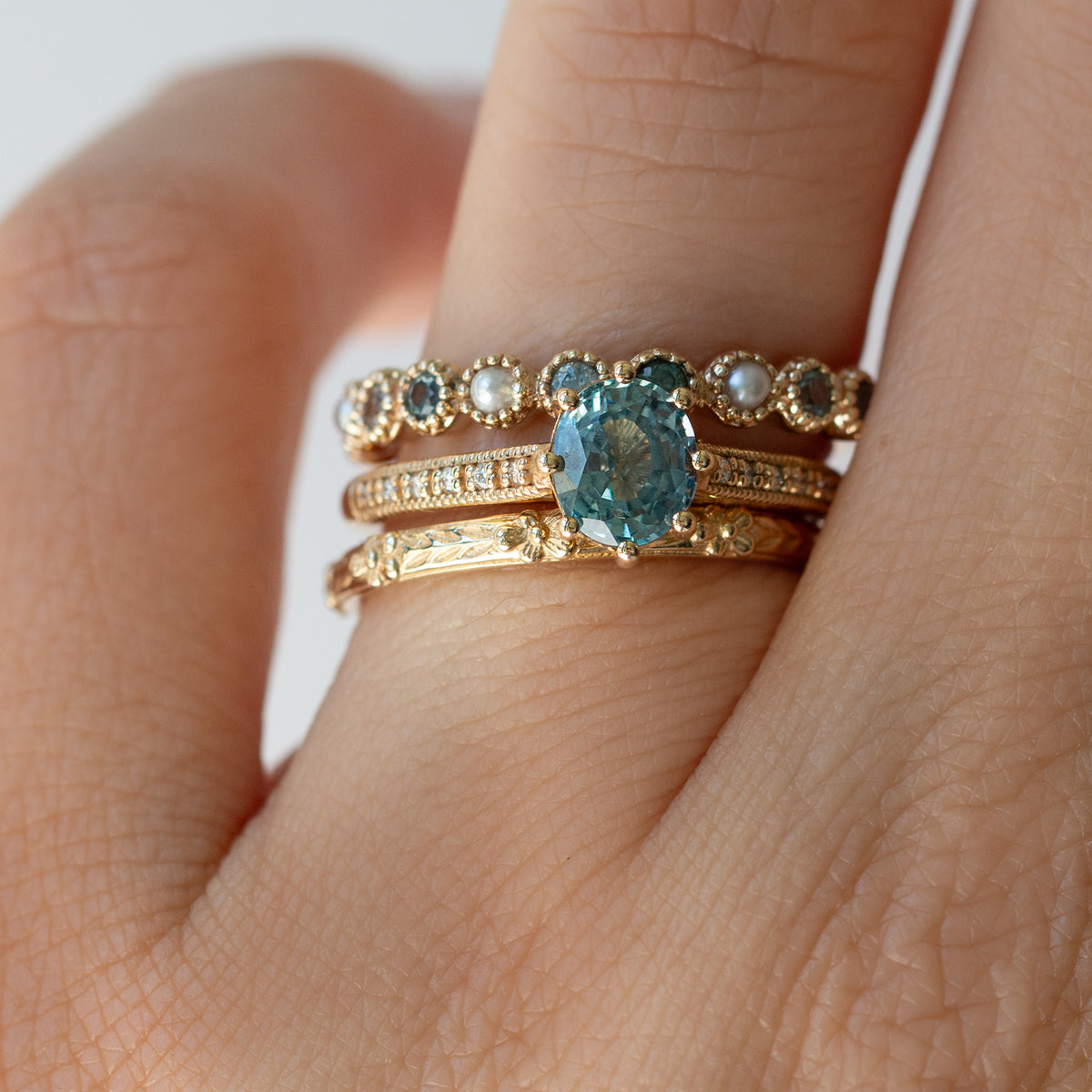 gemstone rings on a finger. 