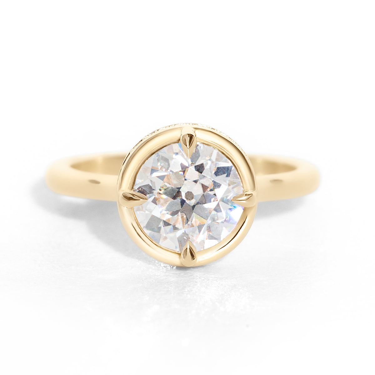 The Riviera Hidden Halo Ring features a 2ct Old European cut diamond or moissanite set in a collet setting, with a delicately highlighted hidden halo beneath. This elegant and romantic design effortlessly blends old-world charm with a modern aesthetic. It’s the perfect choice for engagements, milestone celebrations, birthdays, and anniversaries, making it a timeless piece.