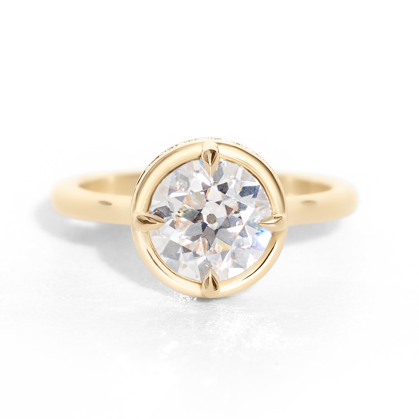 The Riviera Hidden Halo Ring features a 2ct Old European cut diamond or moissanite set in a collet setting, with a delicately highlighted hidden halo beneath. This elegant and romantic design effortlessly blends old-world charm with a modern aesthetic. It’s the perfect choice for engagements, milestone celebrations, birthdays, and anniversaries, making it a timeless piece.