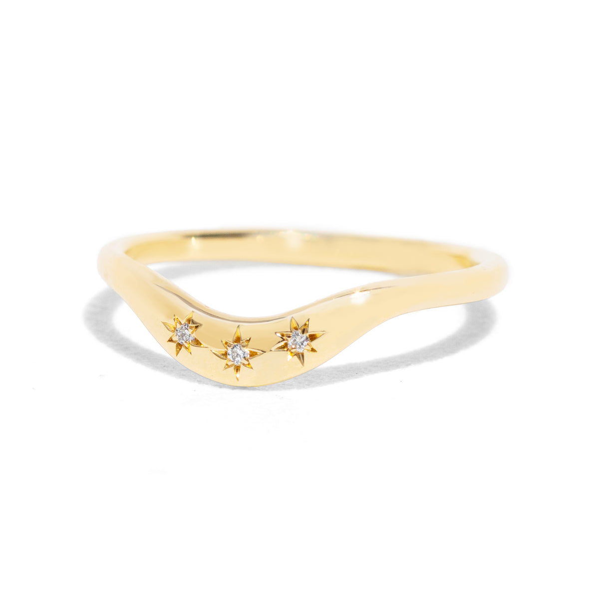 This gently curved, sculpted Starburst Diamond Contour Band is designed to complement your engagement ring with effortless elegance. Its graceful silhouette and subtle sparkle make it a timeless accent to your ring stack.