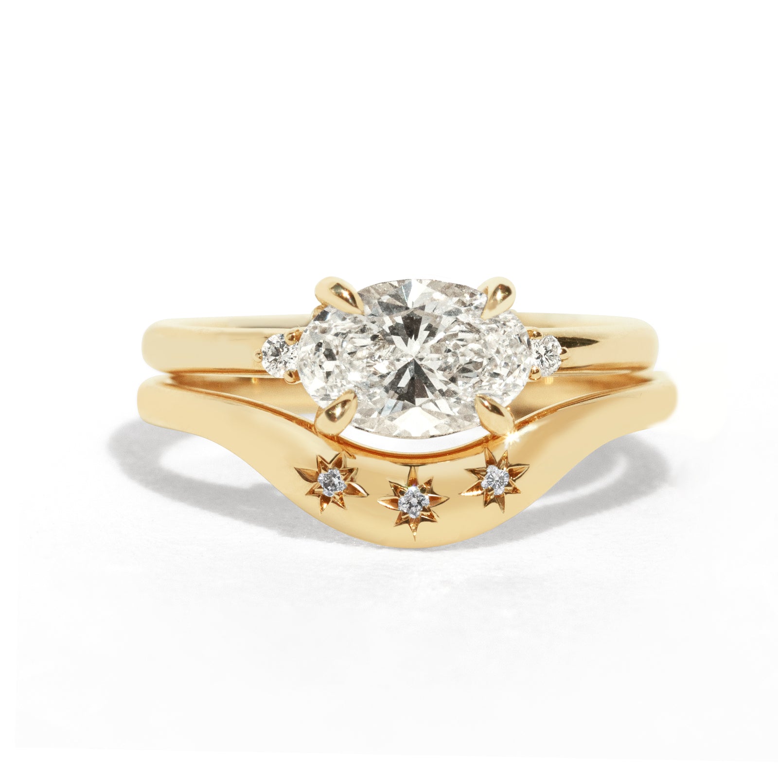 This gently curved, sculpted Starburst Diamond Contour Band is designed to complement your engagement ring with effortless elegance. Its graceful silhouette and subtle sparkle make it a timeless accent to your ring stack.