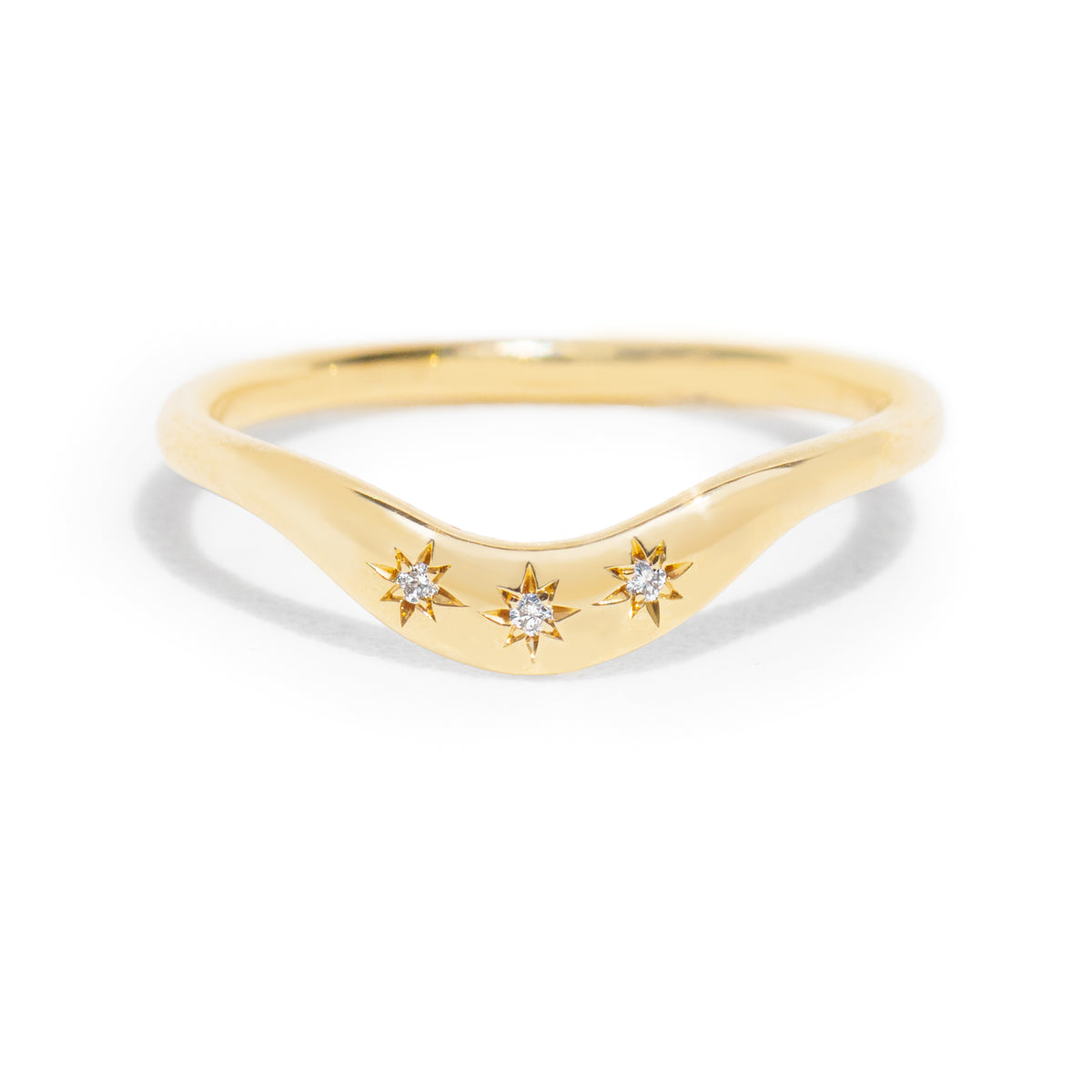 This gently curved, sculpted Starburst Diamond Contour Band is designed to complement your engagement ring with effortless elegance. Its graceful silhouette and subtle sparkle make it a timeless accent to your ring stack.