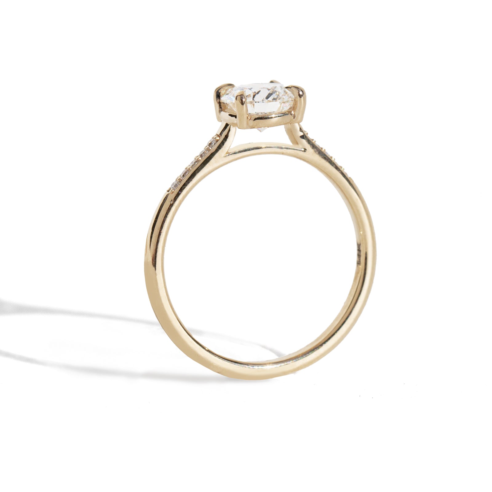 Gold ring with a diamond on a white background