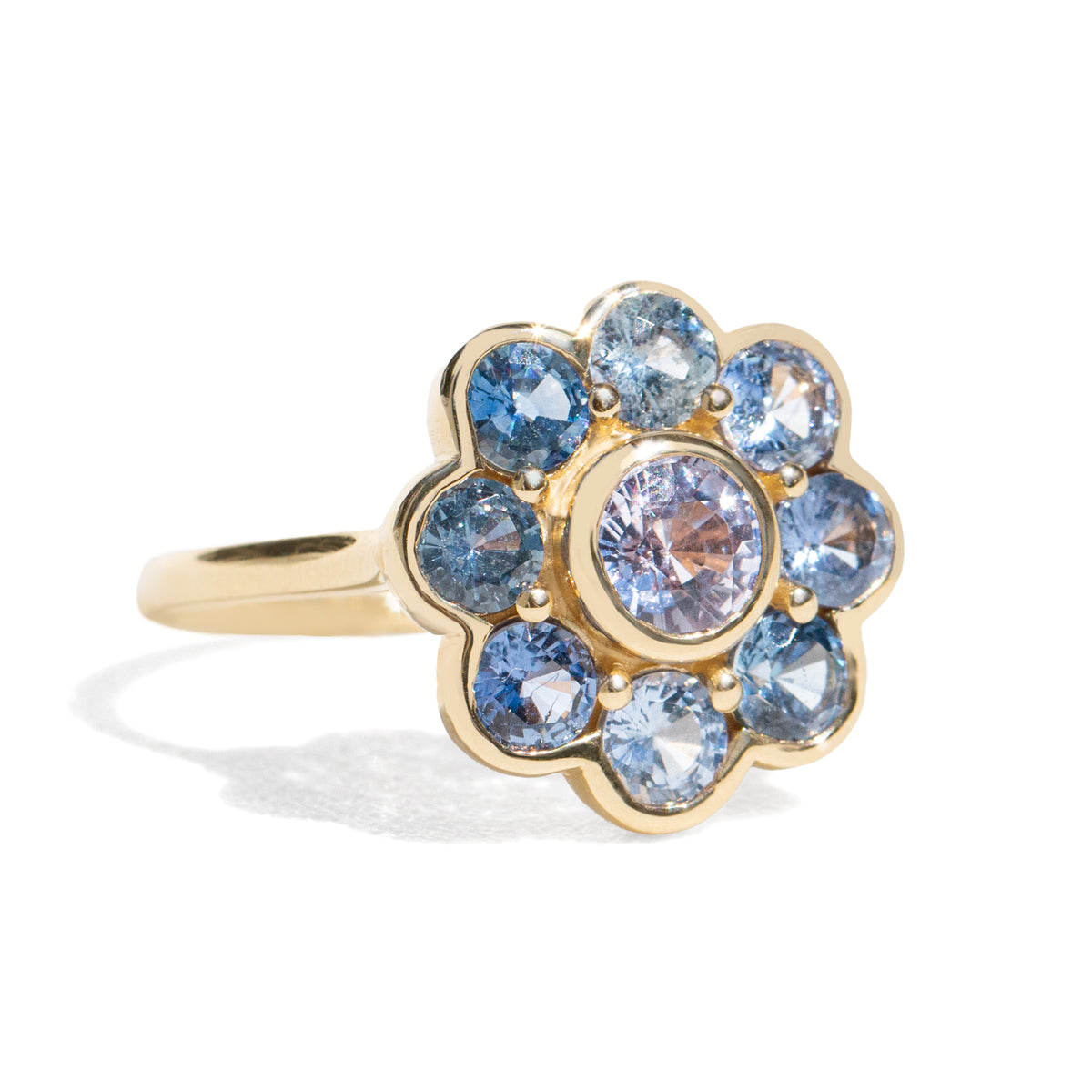 Gold ring with blue sapphires on white background
