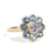 Gold ring with blue gemstones on a white background