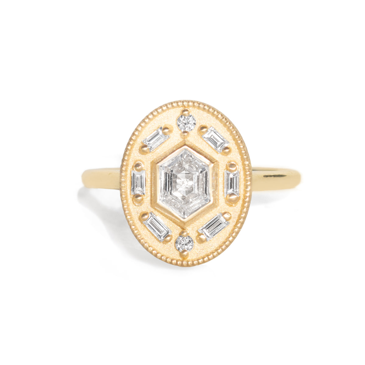 Gold ring with diamond accents around a hexagon diamond in the center on a white background