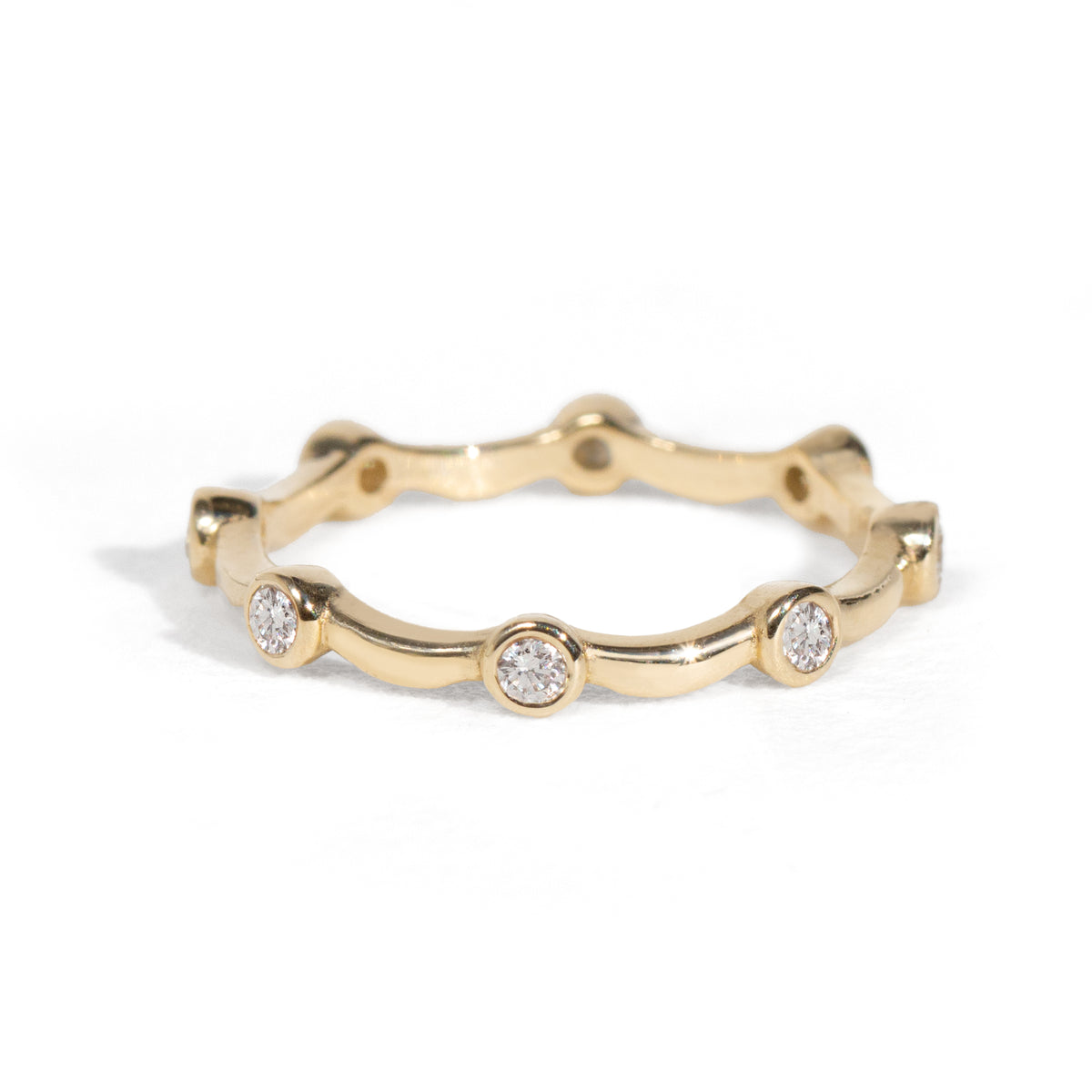 Gold ring with small diamonds on a white background
