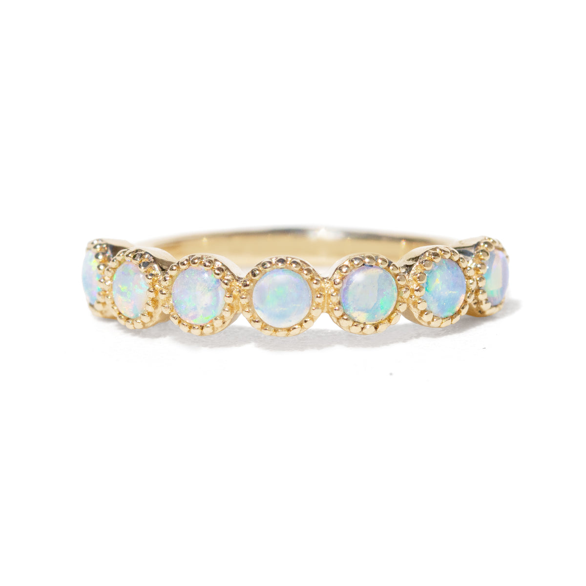 14K Gold ring with opal stones in a beaded setting on a white background