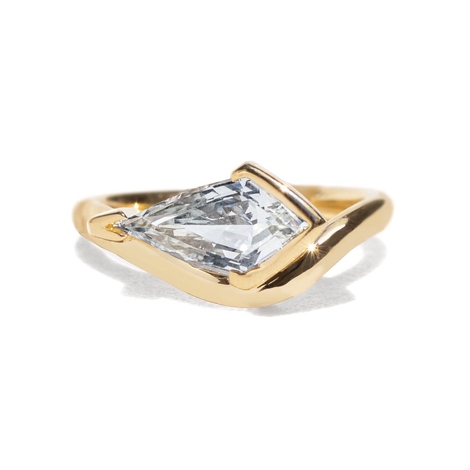 Gold ring with a large sapphire on a white background