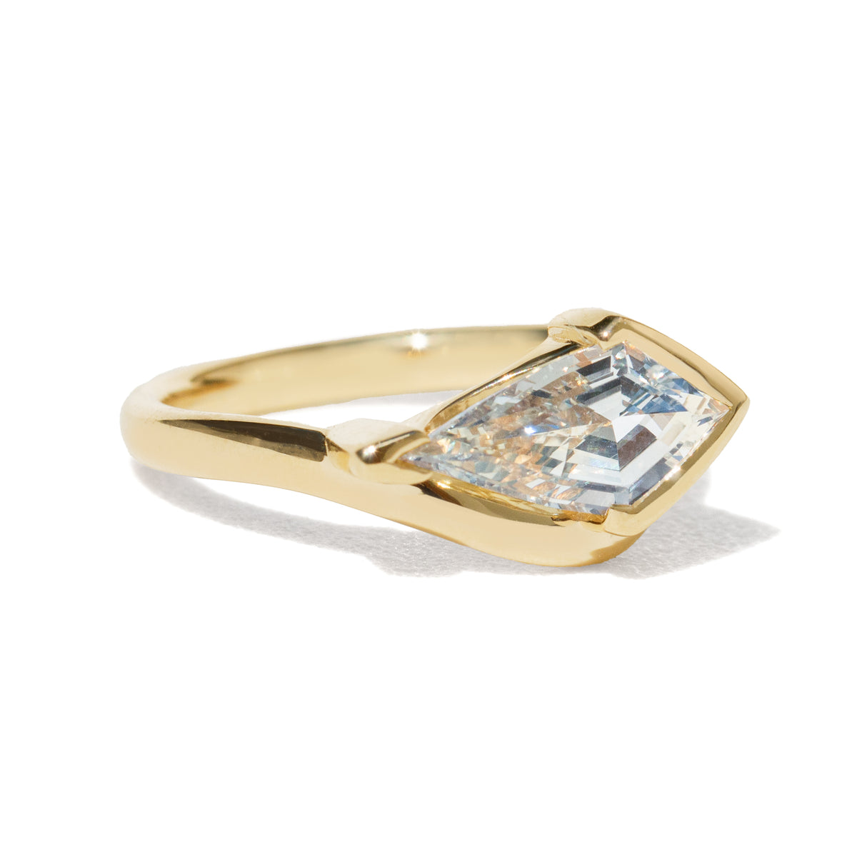 Gold ring with a large sapphire on a white background