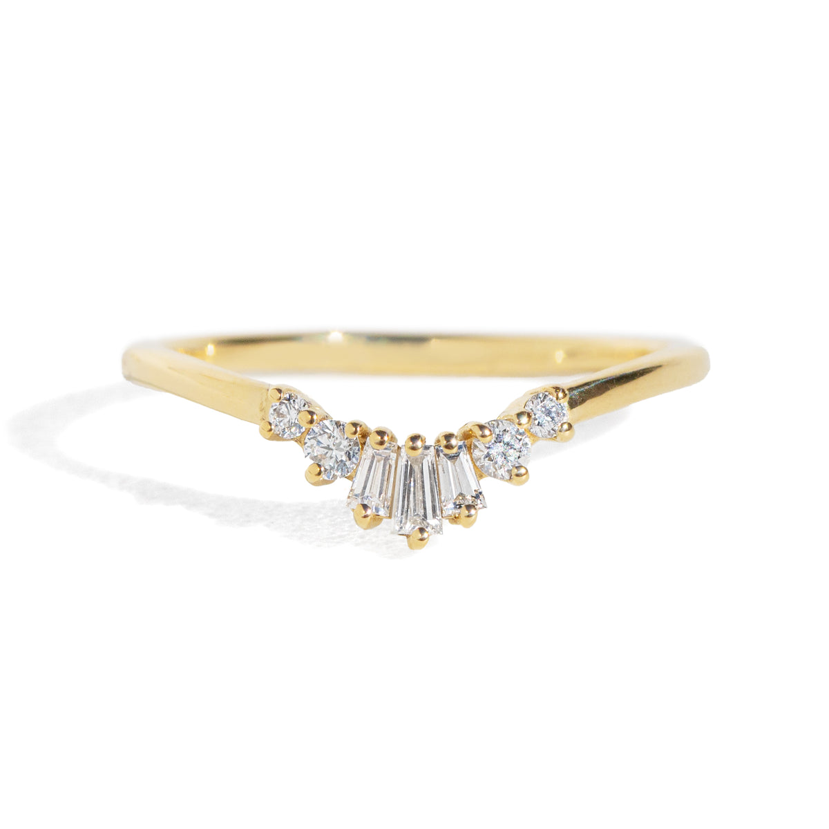 Gold ring with diamond accents on a white background