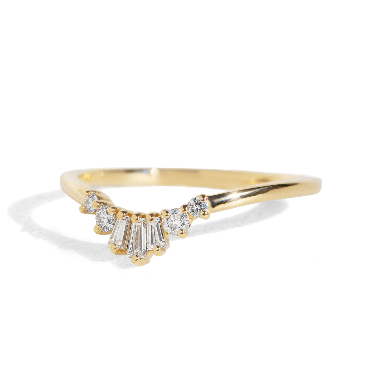 Gold ring with diamond accents on a white background