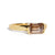 Gold ring with an emerald cut champagne diamond  on a white background