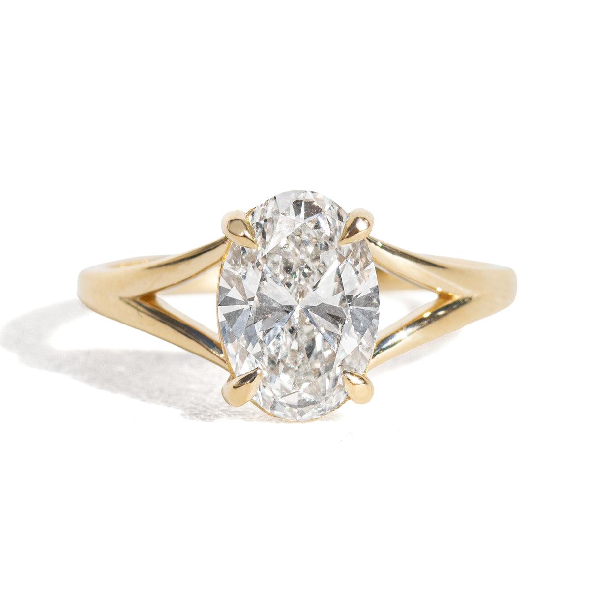 Gold ring with a large diamond on a white background