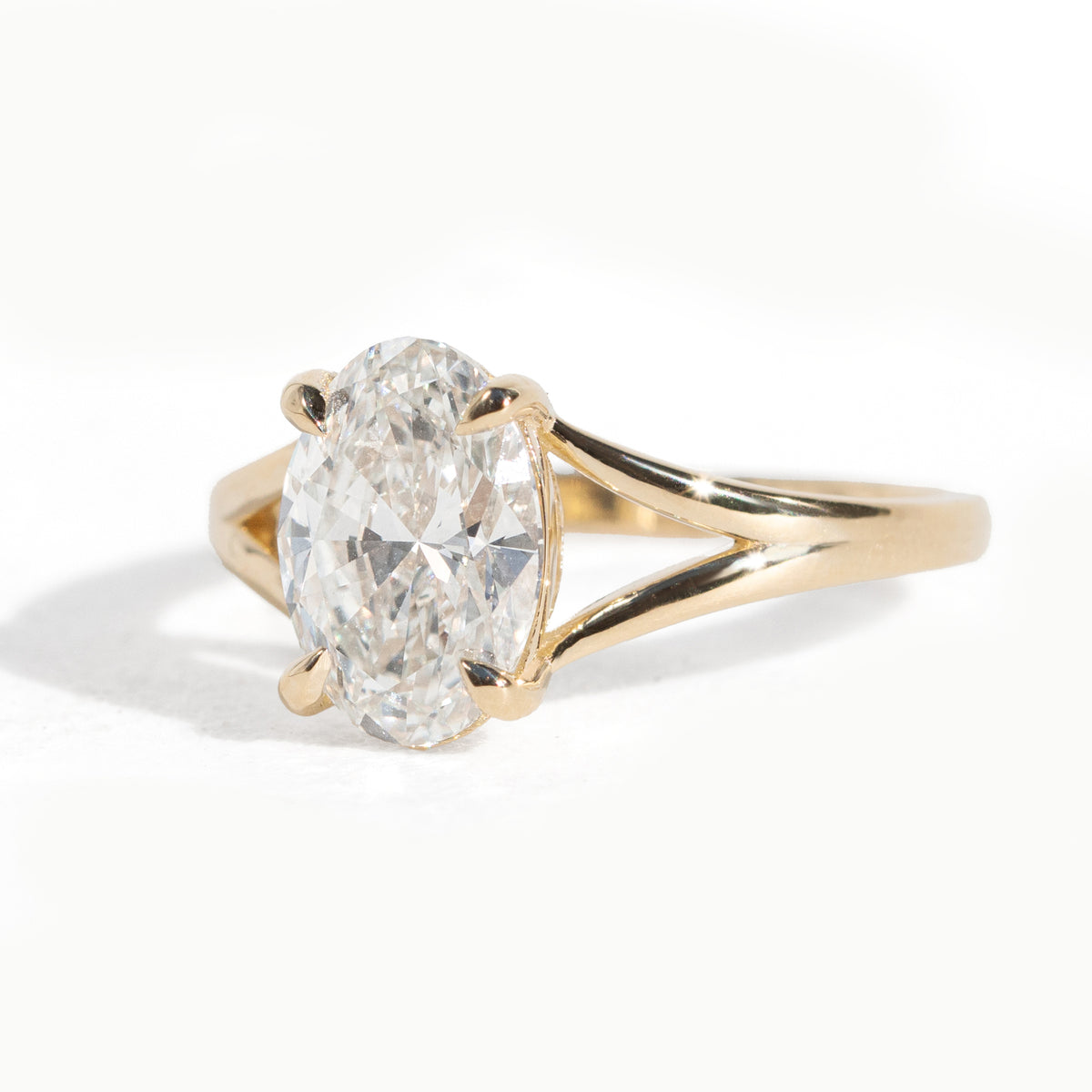 Gold ring with a large diamond on a white background