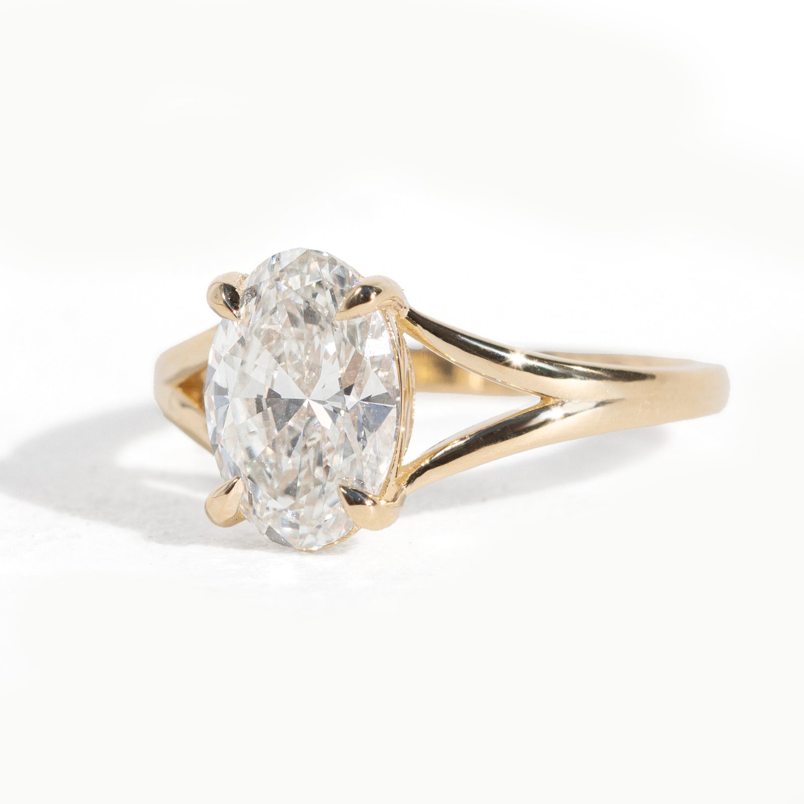 Gold ring with a large diamond on a white background
