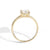 Gold ring with a clear gemstone on a white background