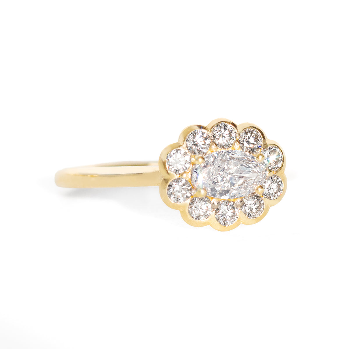 Gold ring with a diamond cluster on a white background