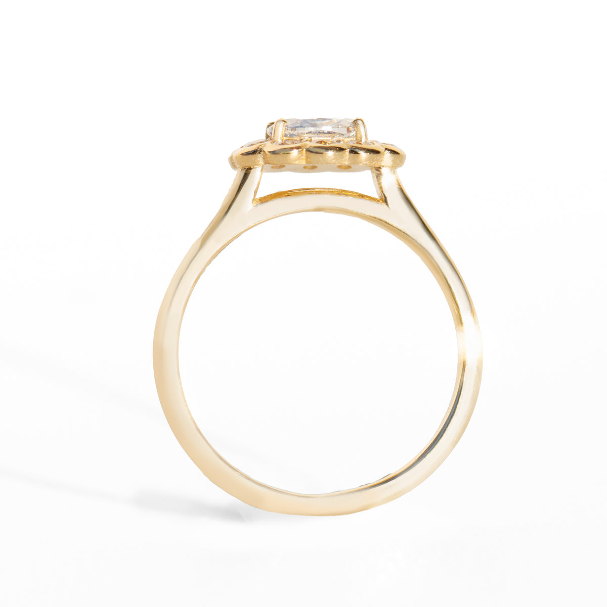 Gold ring with a diamond on a white background