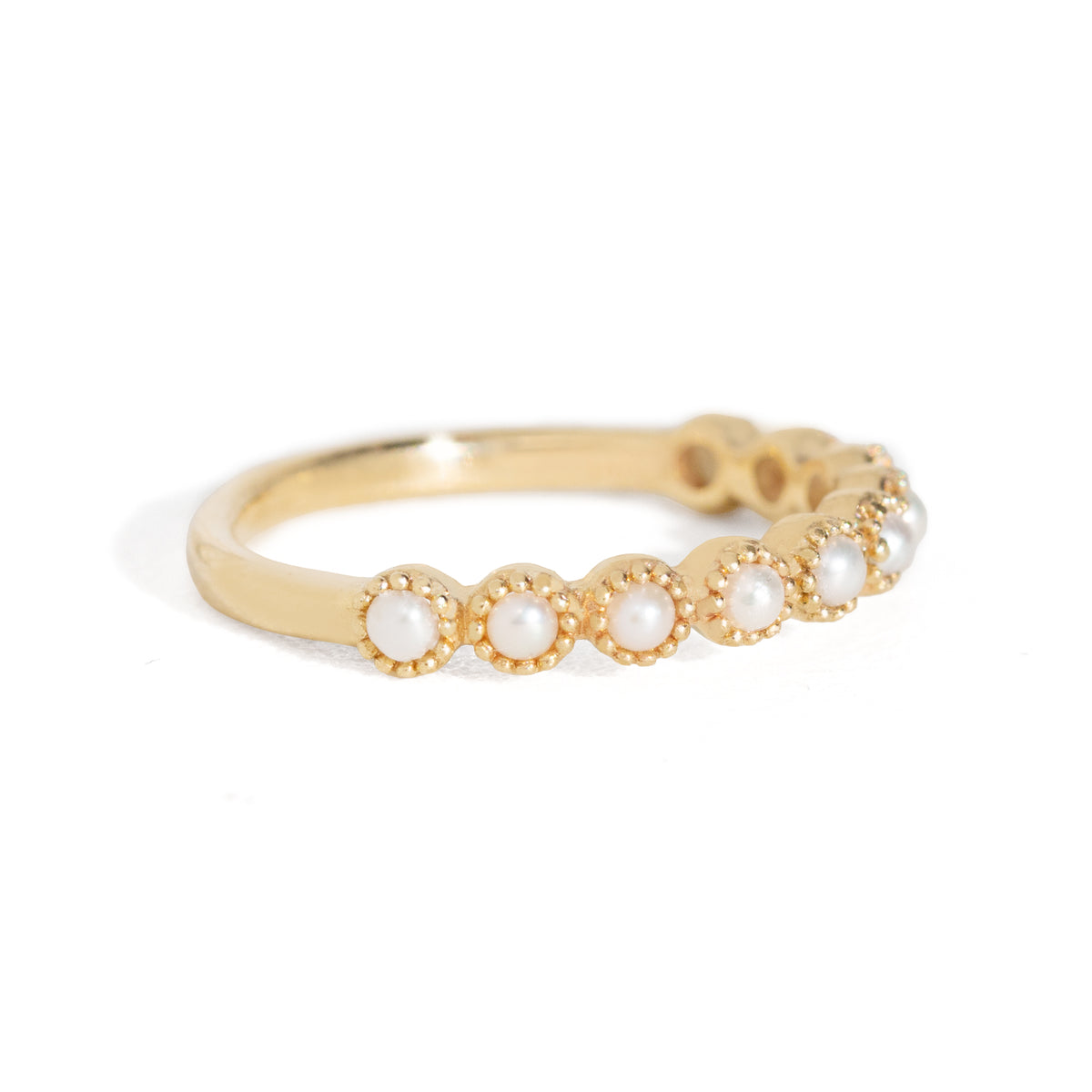 Gold ring with pearls on a white background