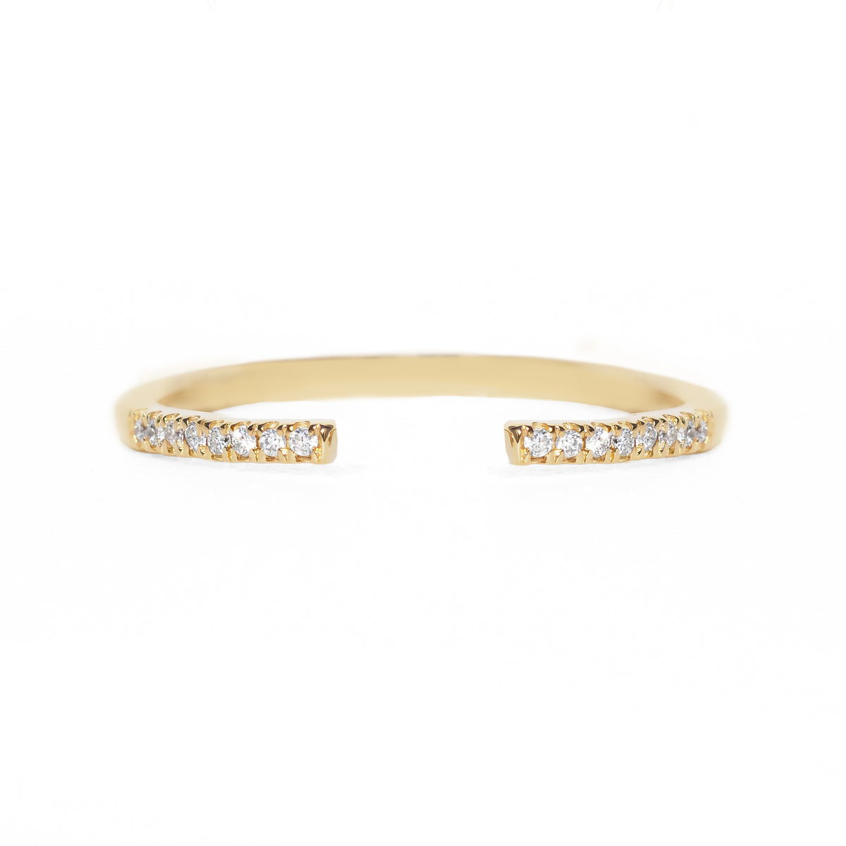 Open gold band with small diamonds on a white background