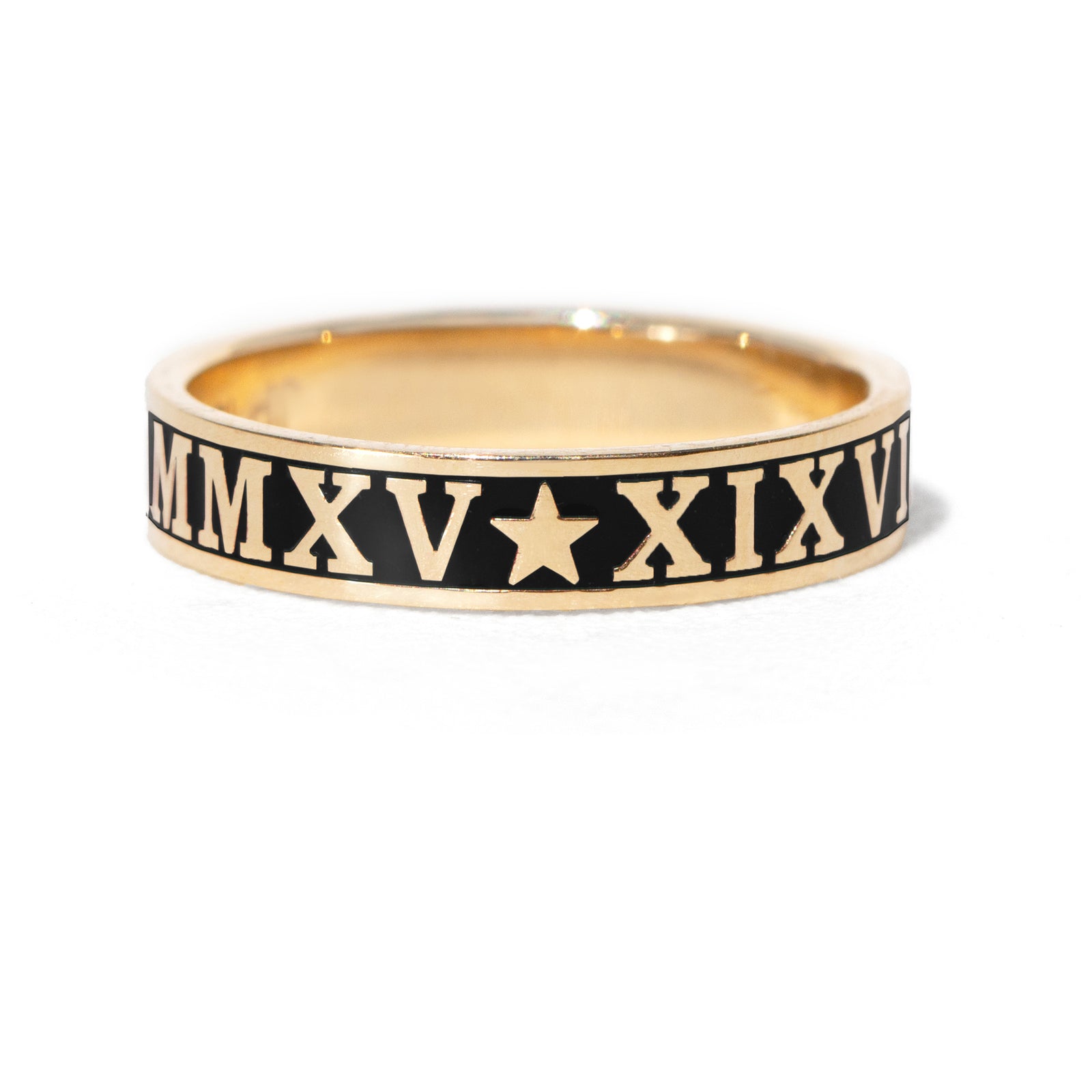 Gold ring with Roman numerals and a star on a white background
