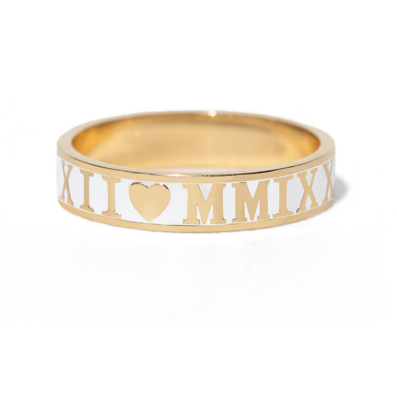 Gold ring with Roman numerals and heart symbol on a white background
